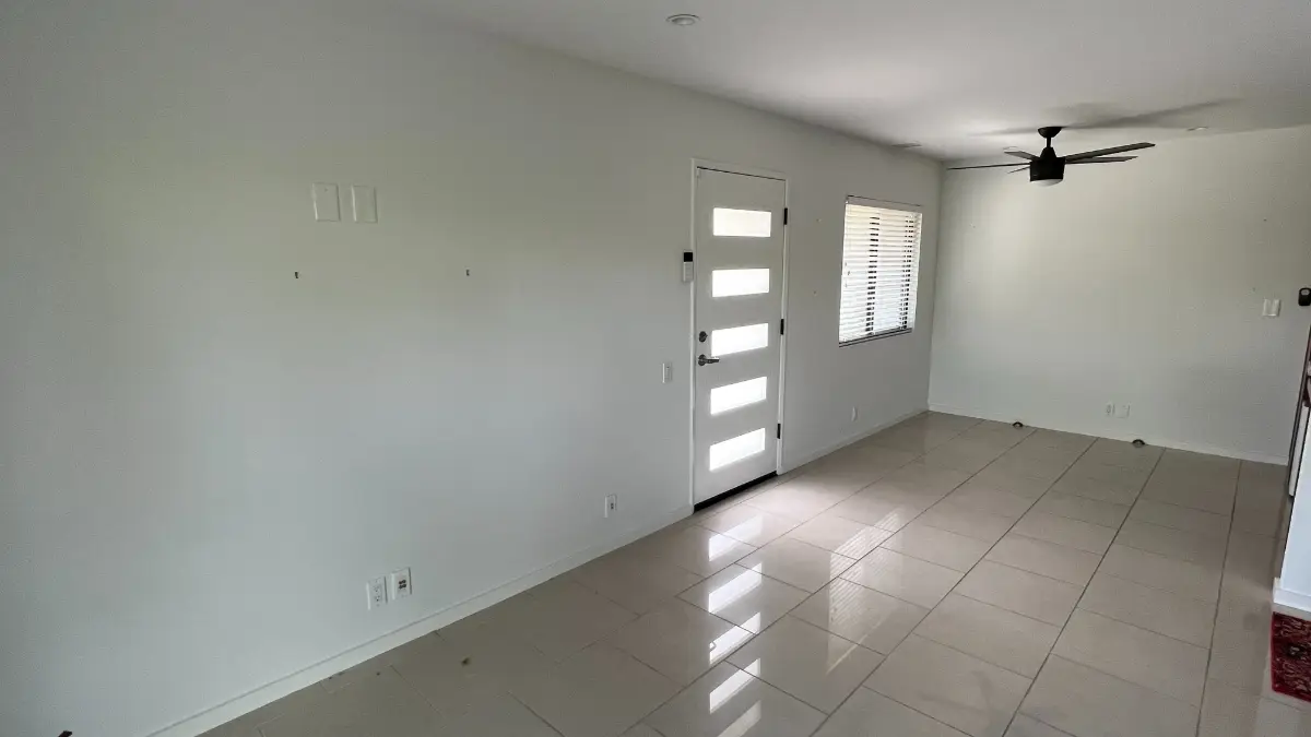 The same Anthem living room empty, white tile and front door clear