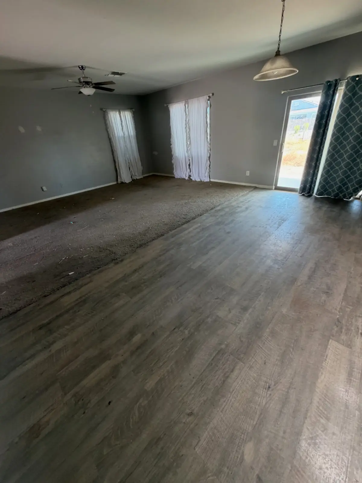 The same Chandler living and dining room cleared to the plank floor and carpet