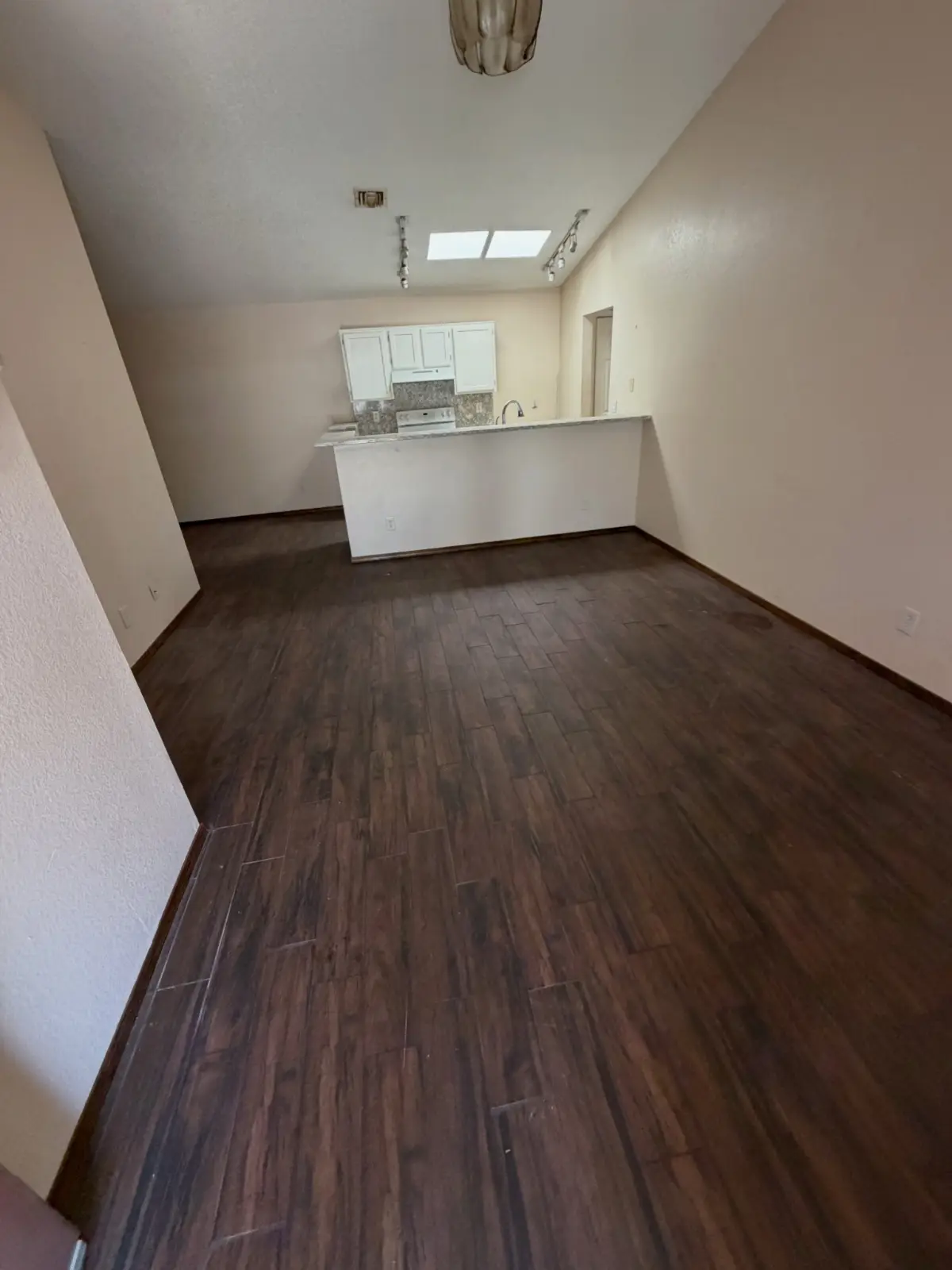 The same Gilbert living room empty through to the kitchen