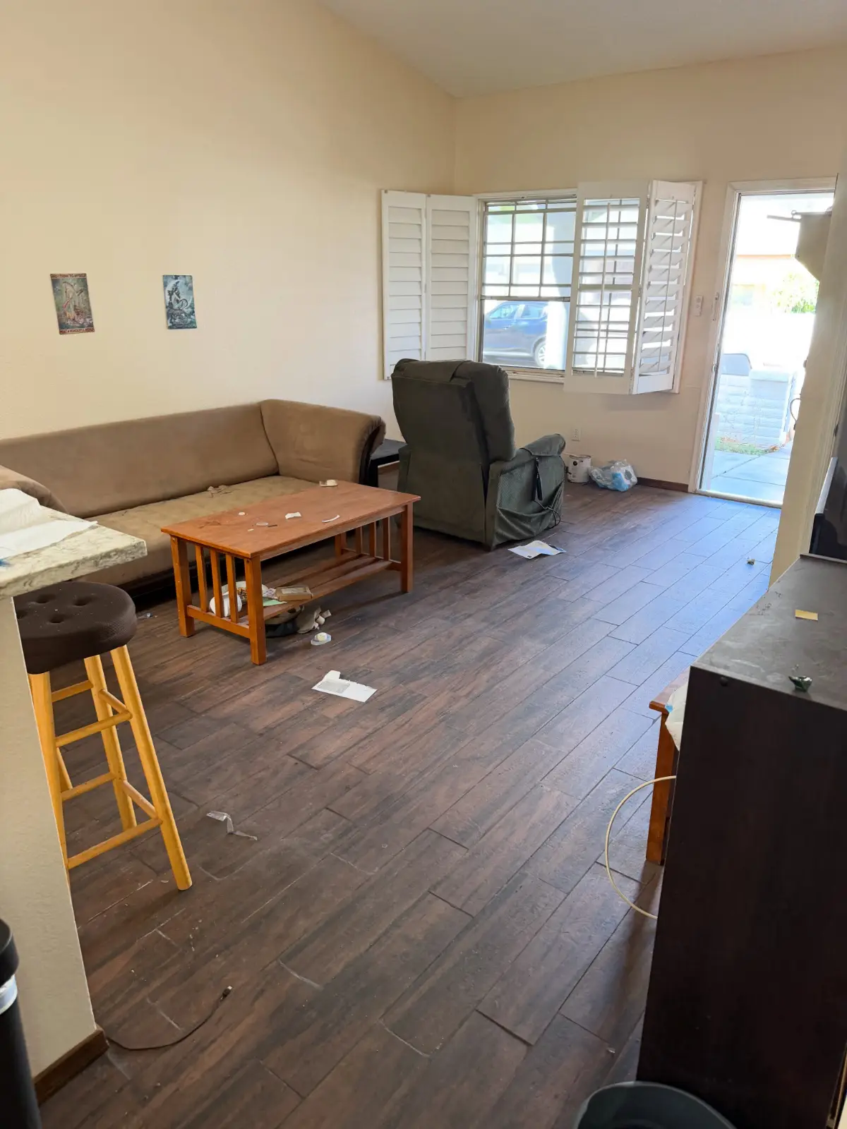A Gilbert living room with a sofa, a recliner, a coffee table and a stool on dark wood-look tile