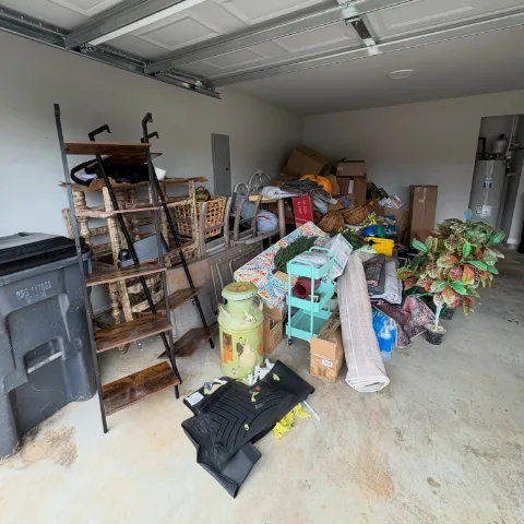 A Gilbert garage full of furniture and boxes before a Haulo cleanout