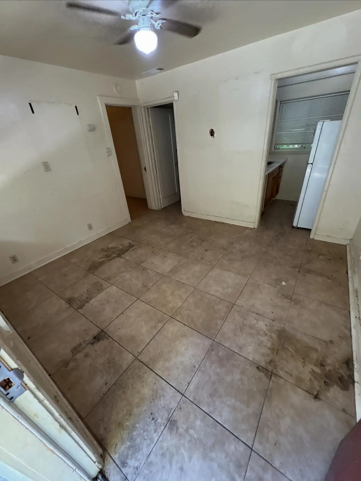 The same Gilbert kitchen entry cleared, with the refrigerator and cabinets visible