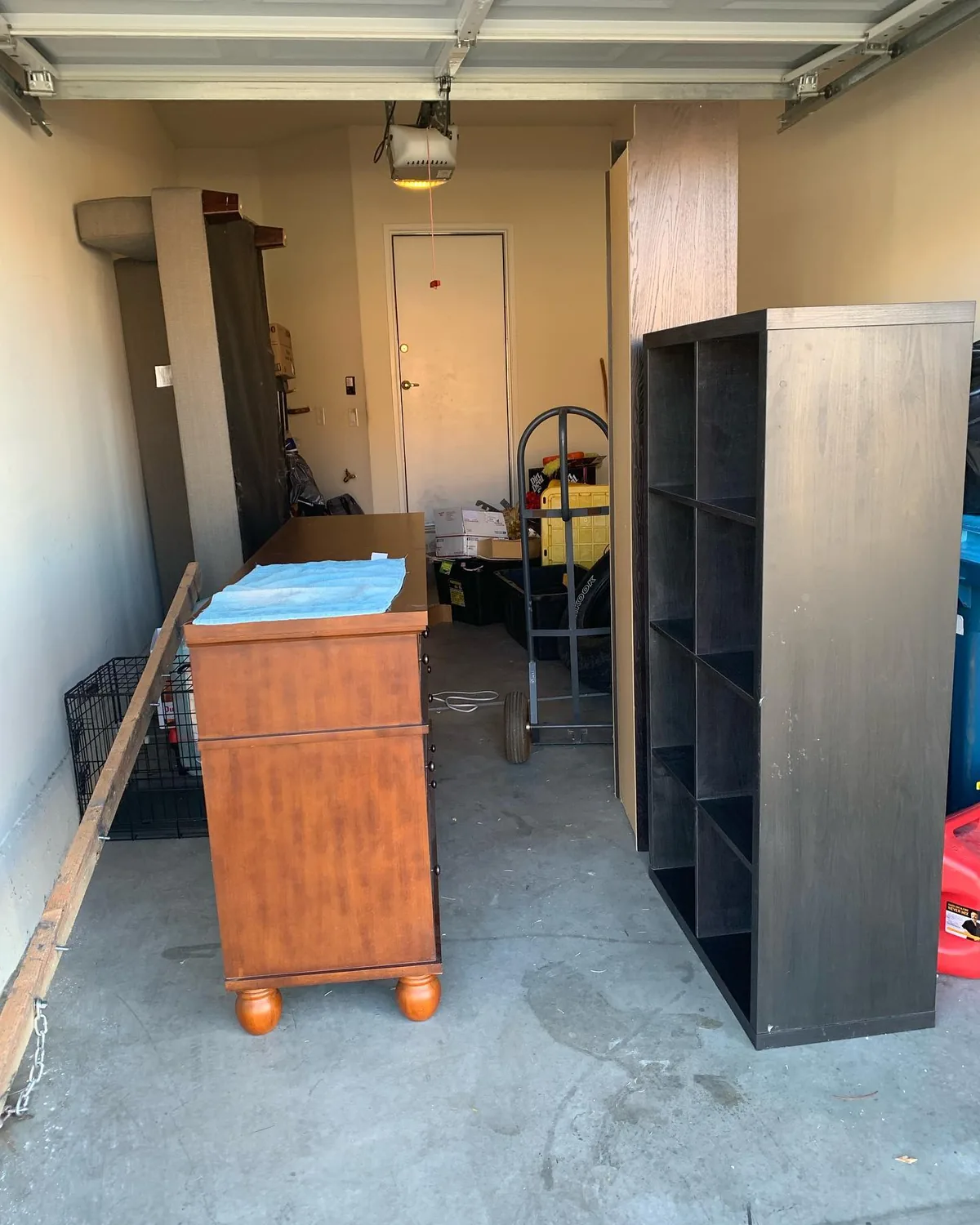 Bulky furniture, shelving, boxes, and storage items in a Gilbert garage before junk removal