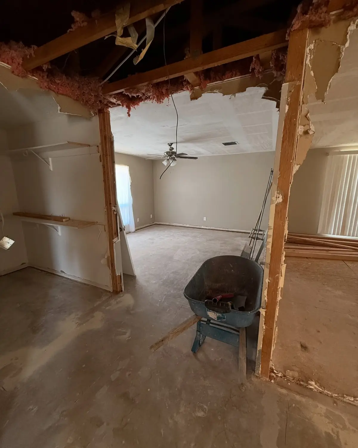 The same Mesa bedroom cleared of insulation; a wheelbarrow and a lumber stack stayed at the customer's request