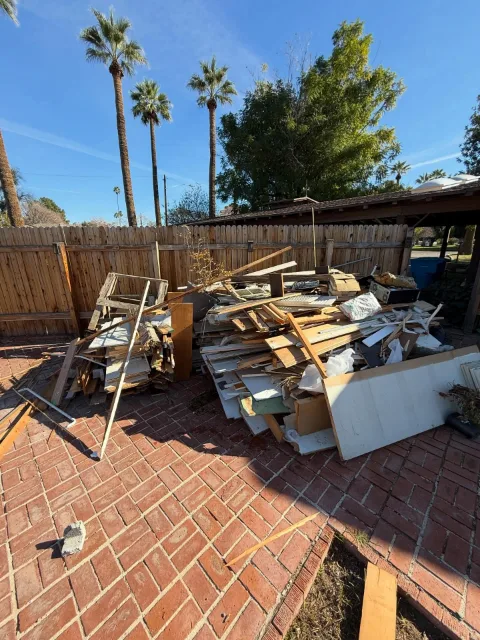 Remodel debris pile on a brick patio at a Mesa home before pickup