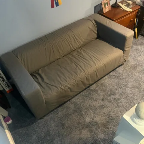 Grey sectional couch in a Mesa bedroom before Haulo carried it out