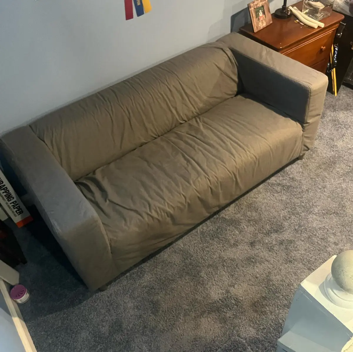 Grey sectional couch against a bedroom wall beneath a wall-mounted TV in a Mesa home