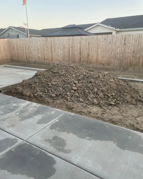 Mound of excavated dirt beside a concrete slab at a Mesa property