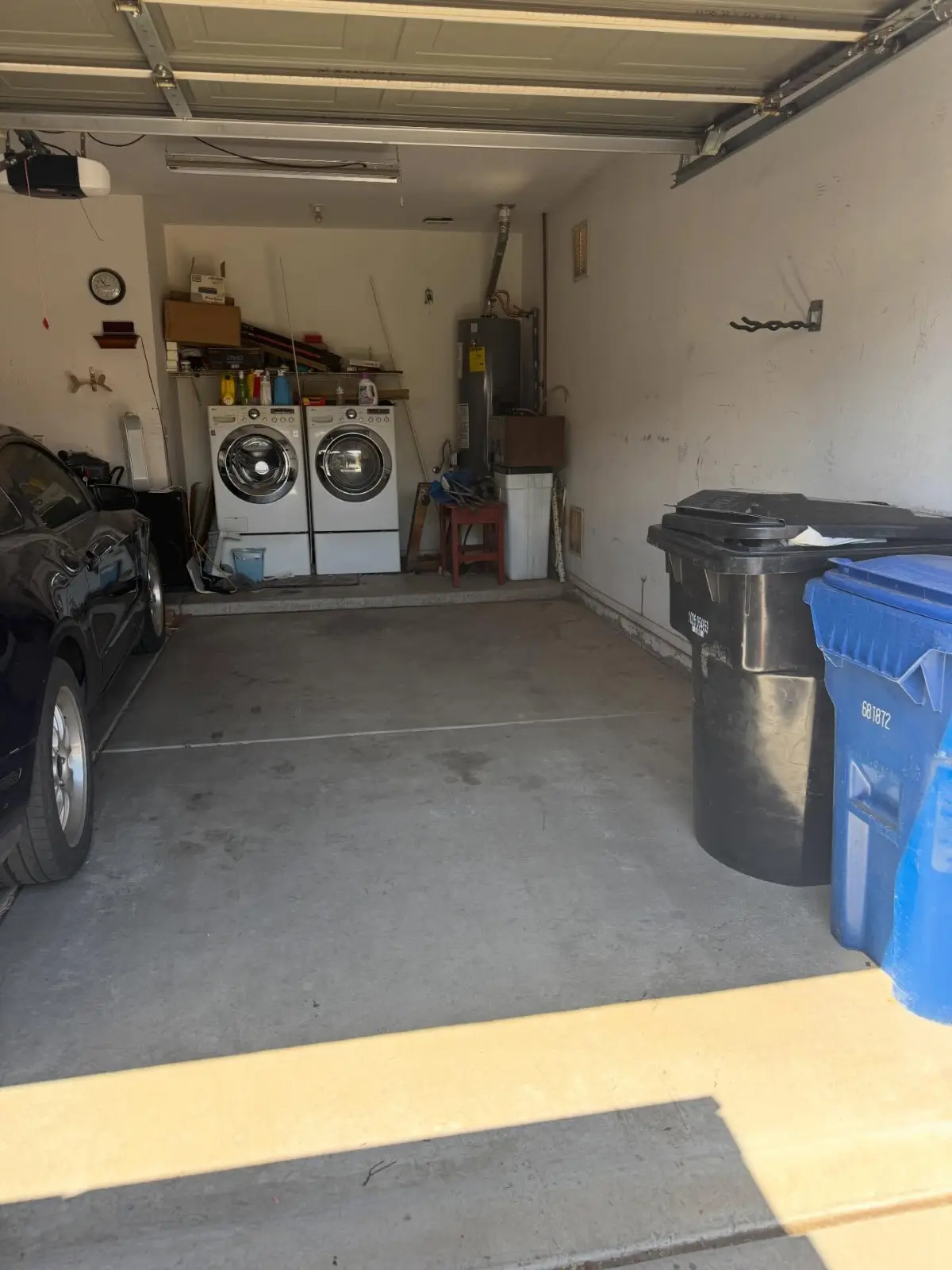 The same Mesa garage bay cleared back to the washer and dryer, with the car, bins and shelving still in place