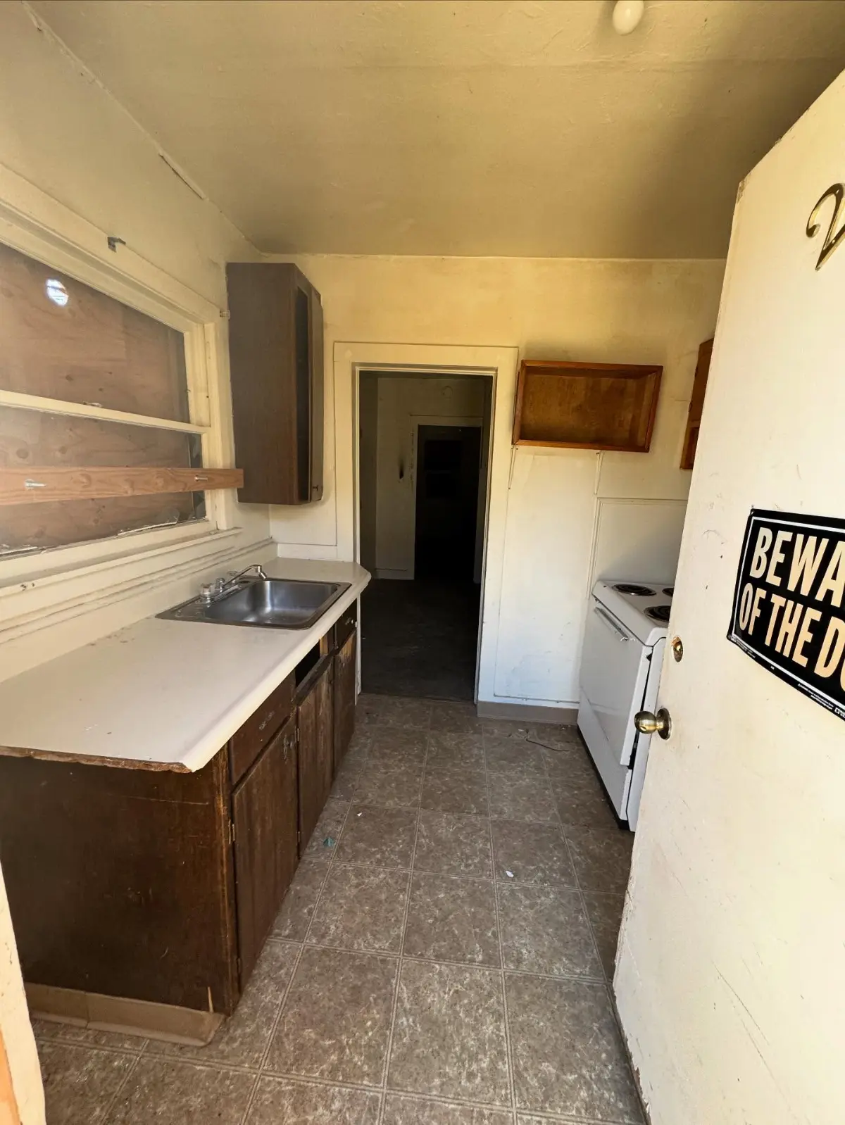 The same Mesa galley kitchen cleared, with the sink, counter and cabinets empty