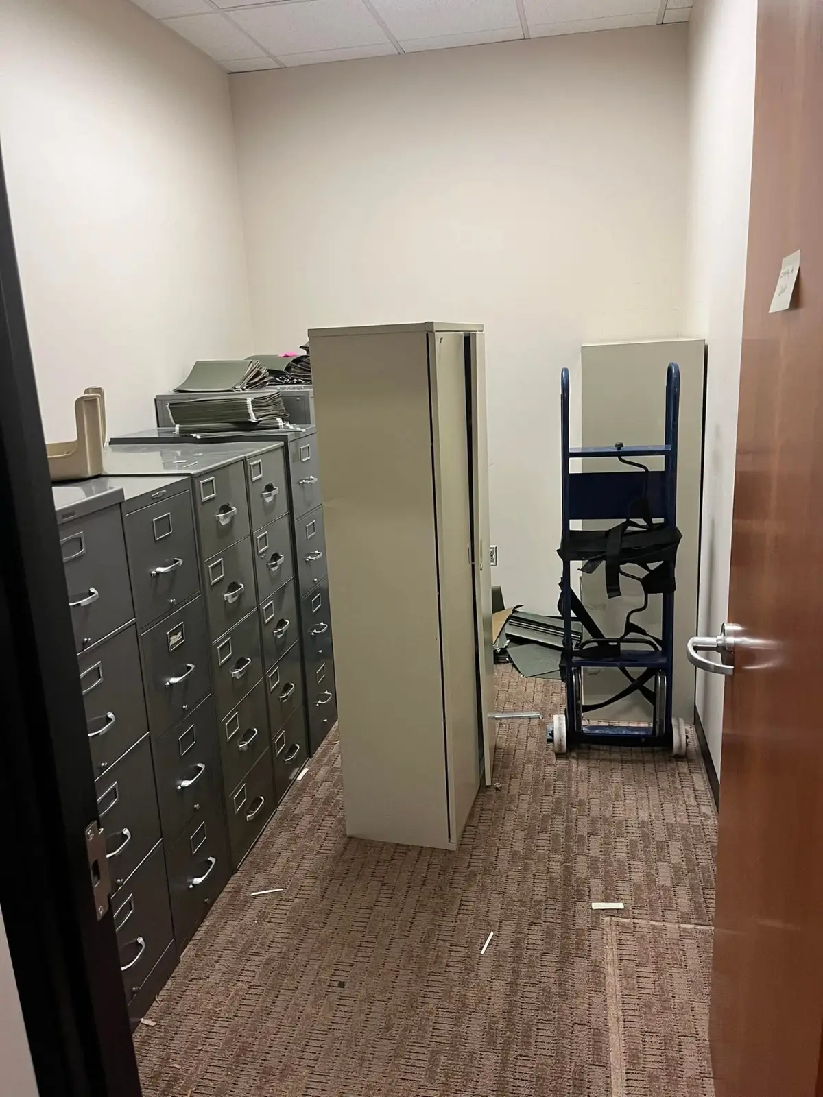 A file room in the same Phoenix office lined with metal filing cabinets and a storage cabinet