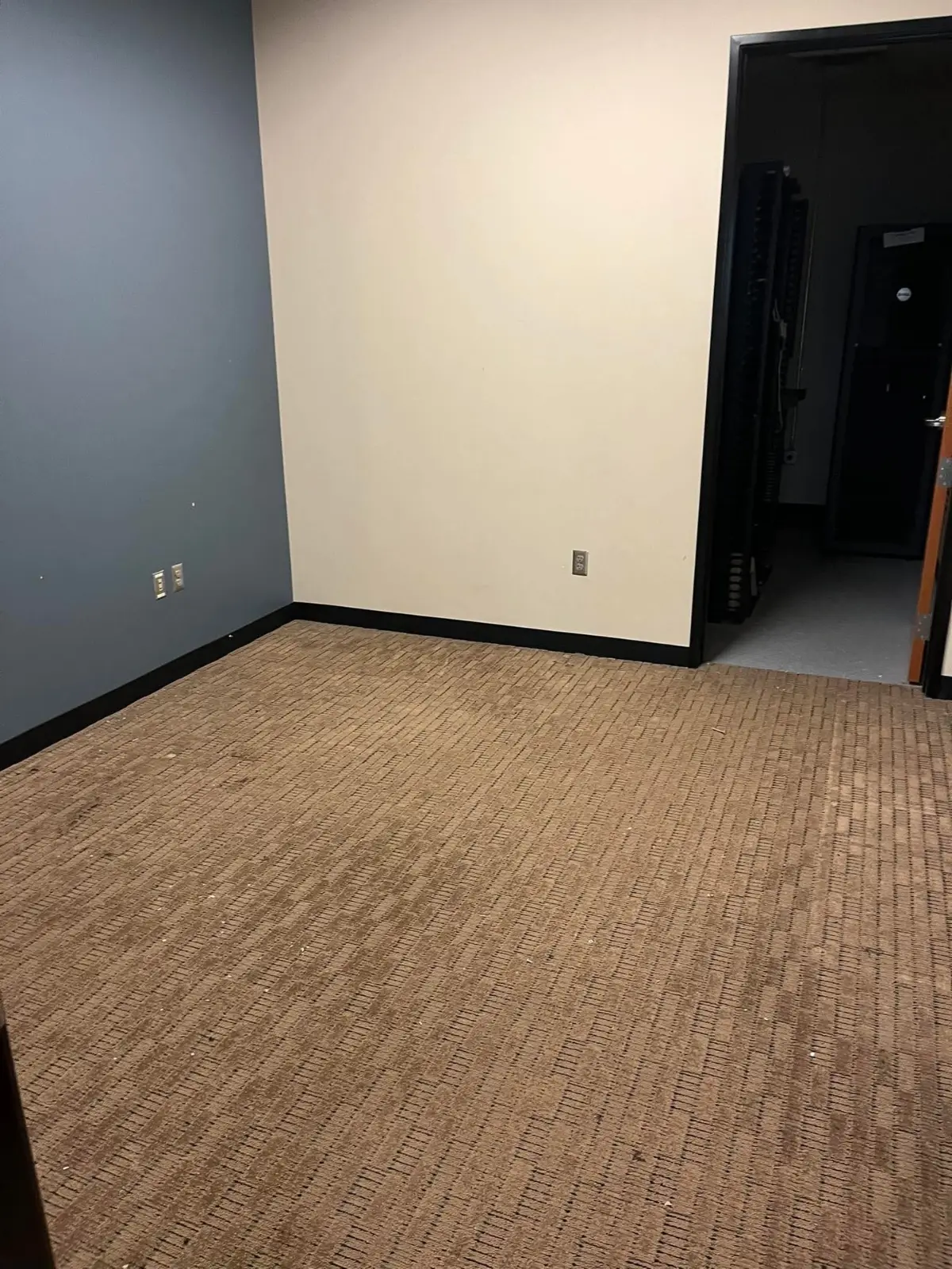 The same Phoenix room cleared to the carpet with the server room visible through the doorway
