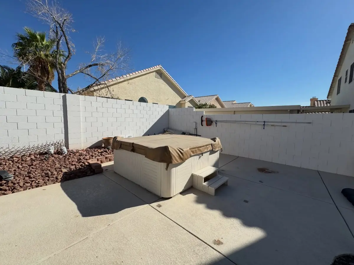 The same Scottsdale patio with the gazebo gone; the hot tub remains