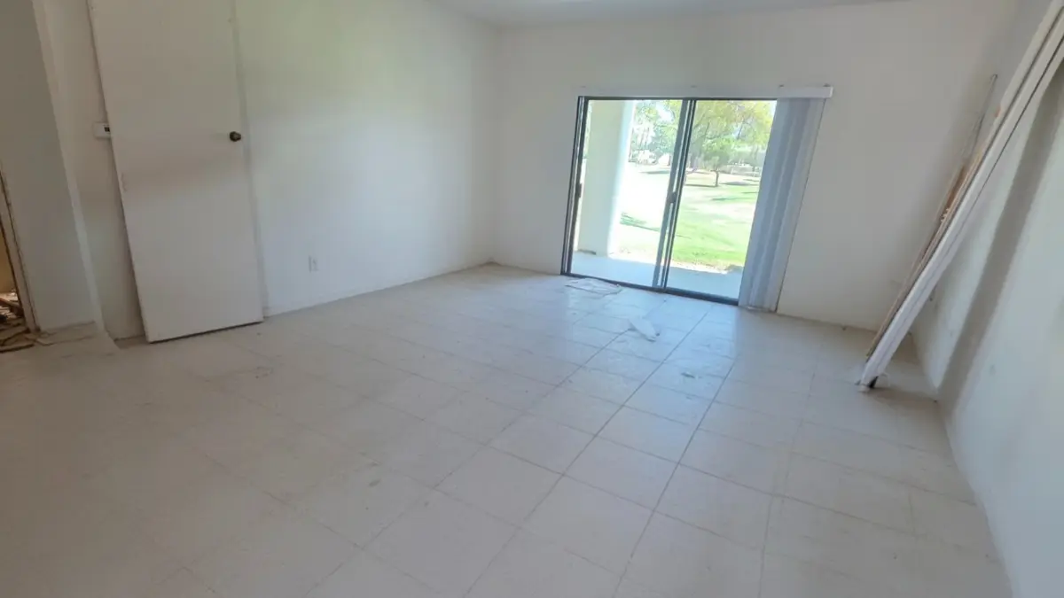 The same Sun Lakes living room cleared to the tile floor with the patio doors open