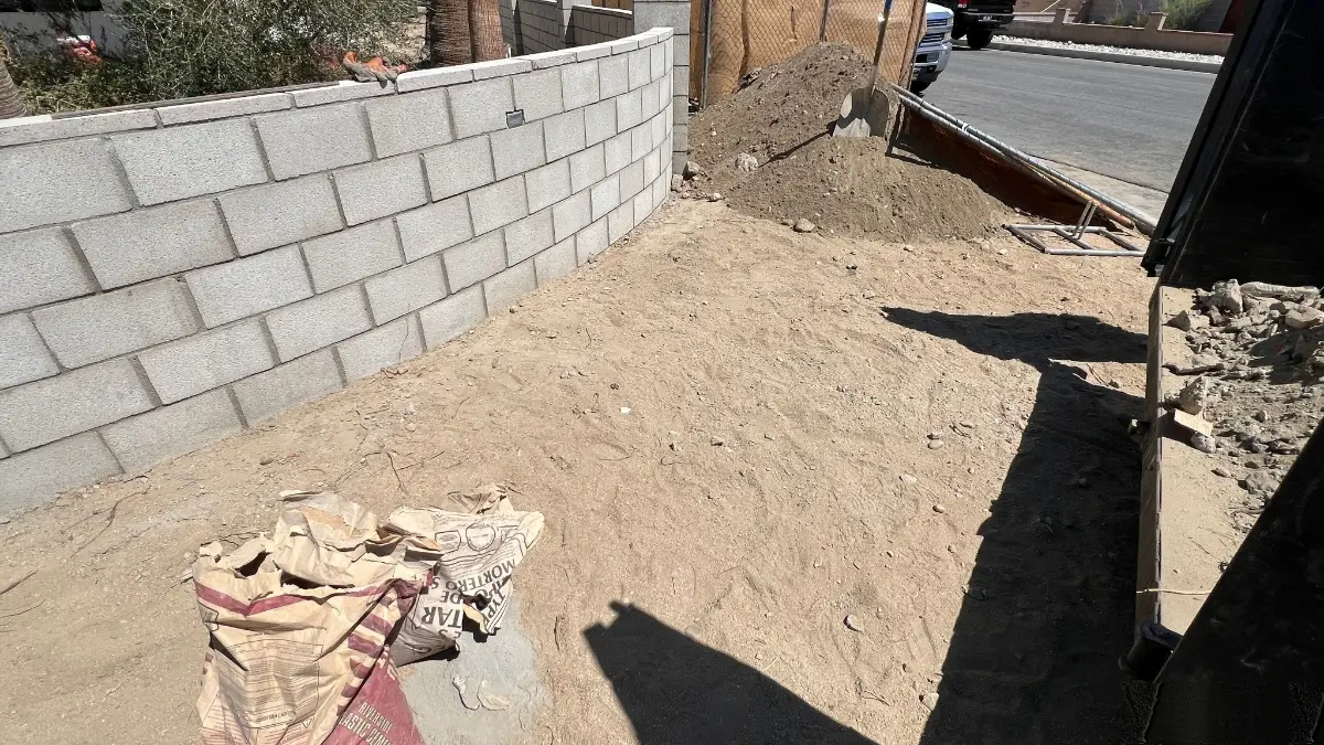 The same Tempe dirt lot cleared along the block wall